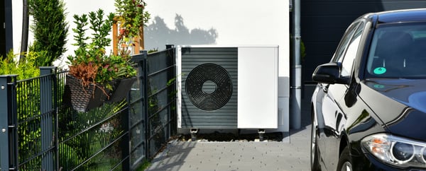 Air-Air Heat Pump for Heating and hot Water in Front of an new built Residential Building_edited